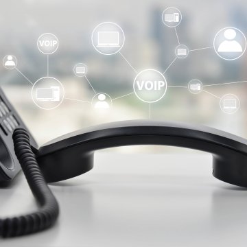 save money voip services benefits black voip phone on desk 